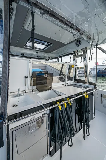 Brama Sole Yacht Photos Pics 2022 Jeanneau Leader 12.5 boat interior with modern kitchen and storage.