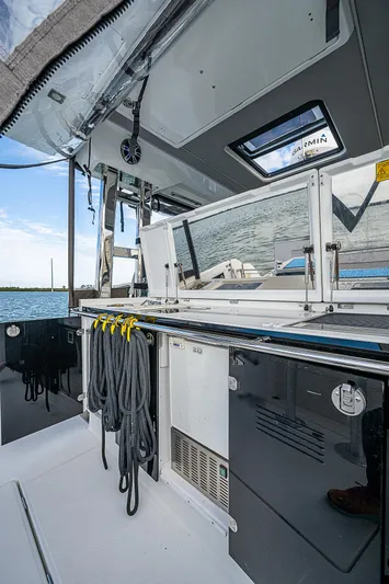 Brama Sole Yacht Photos Pics 2022 Jeanneau Leader 12.5 boat interior with ropes and storage, overlooking water.