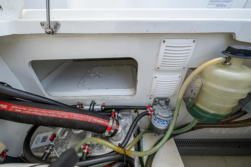 Brama Sole Yacht Photos Pics Engine compartment of 2022 Jeanneau Leader 12.5 boat, showcasing hoses and components.