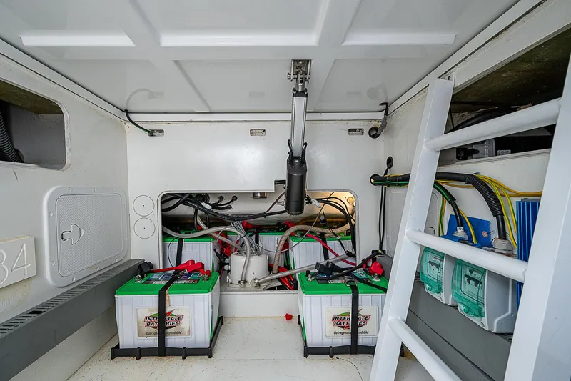 Brama Sole Yacht Photos Pics Battery compartment of 2022 Jeanneau Leader 12.5 boat, featuring multiple batteries and wiring.