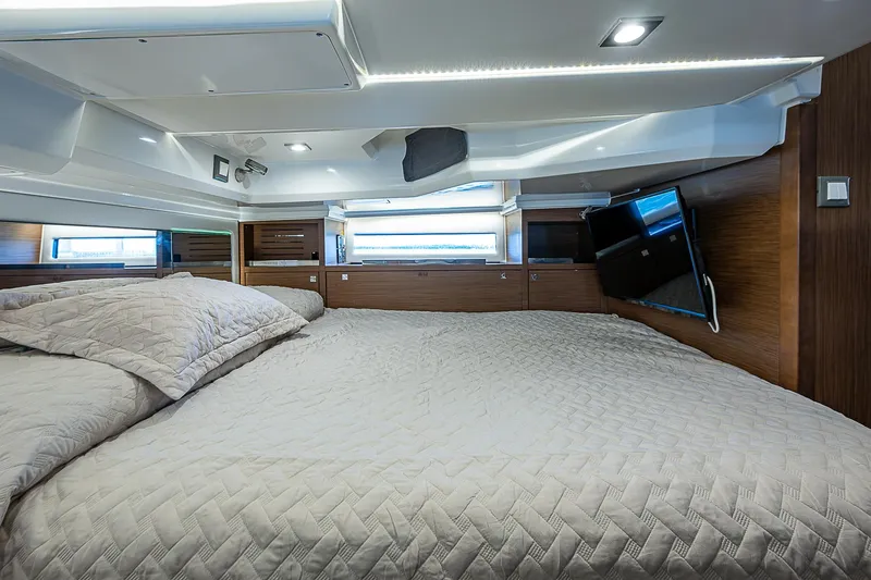 Brama Sole Yacht Photos Pics Luxurious cabin interior of 2022 Jeanneau Leader 12.5 with cozy bedding and modern amenities.