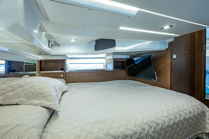 Brama Sole Yacht Photos Pics Luxurious cabin interior of 2022 Jeanneau Leader 12.5 with modern design and cozy bedding.