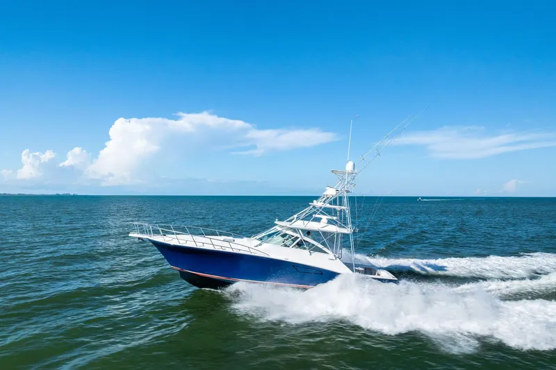 Ebtide Yacht Photos Pics 2006 Cabo 45 Express yacht cruising on open sea under clear blue sky.