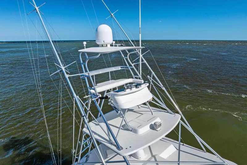 Ebtide Yacht Photos Pics 2006 Cabo 45 Express yacht tower against ocean backdrop, showcasing sleek design and advanced equipment.