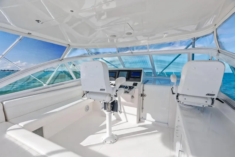 Ebtide Yacht Photos Pics Interior of 2006 Cabo 45 Express yacht with ocean view and modern helm.