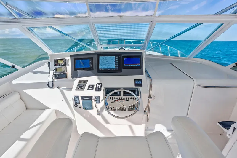 Ebtide Yacht Photos Pics 2006 Cabo 45 Express yacht helm with navigation screens and ocean view.