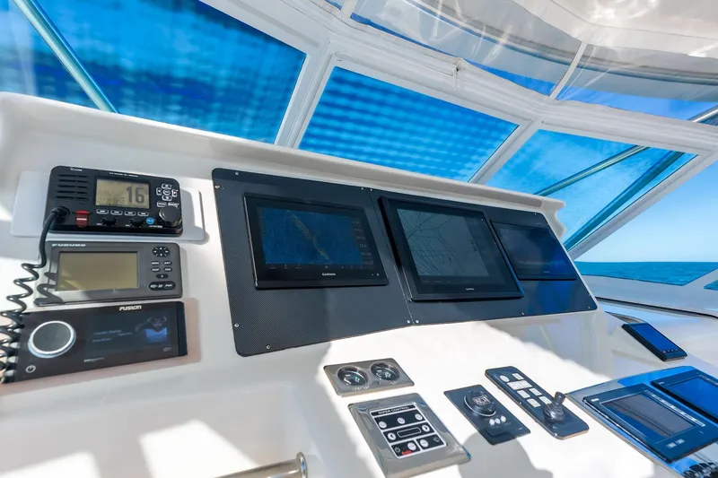 Ebtide Yacht Photos Pics Control panel of 2006 Cabo 45 Express yacht with navigation screens and communication devices.