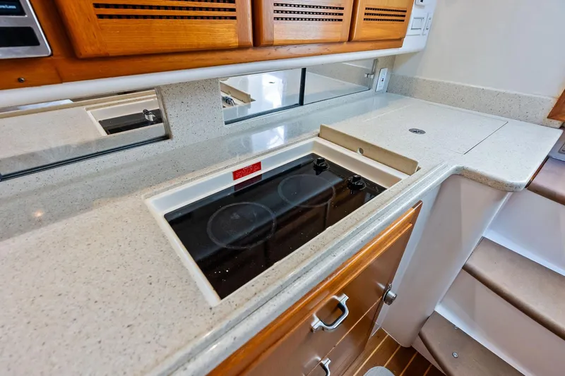Ebtide Yacht Photos Pics 2006 Cabo 45 Express yacht kitchen with sleek countertops and electric stove.
