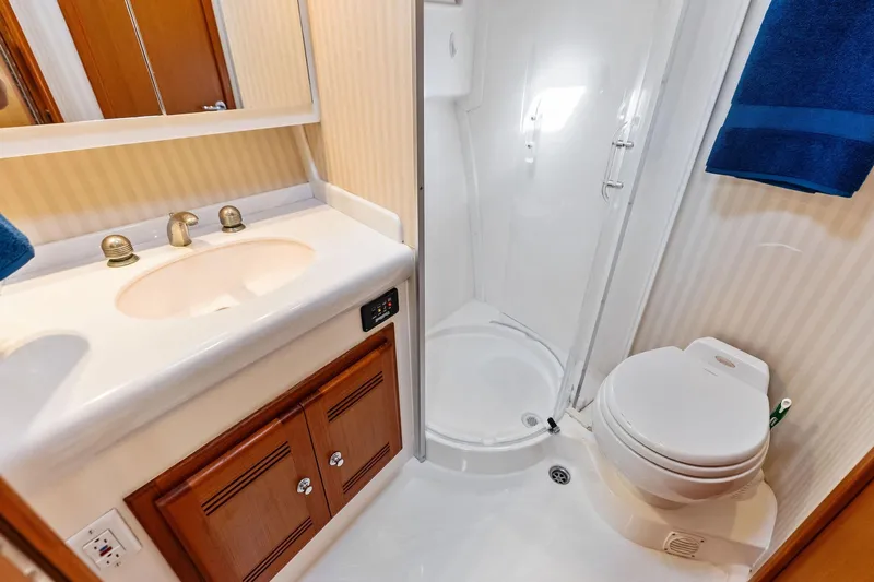 Ebtide Yacht Photos Pics Luxurious 2006 Cabo 45 Express yacht bathroom with shower, sink, and toilet.