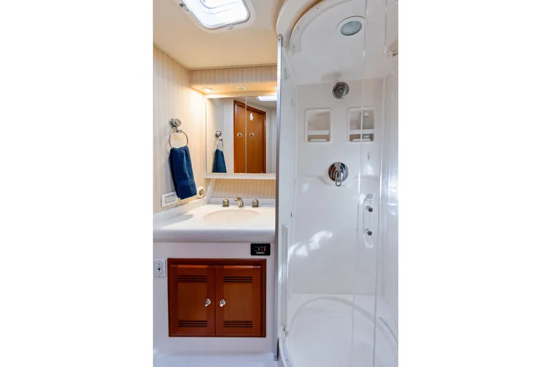 Ebtide Yacht Photos Pics Luxurious bathroom in 2006 Cabo 45 Express yacht with shower and vanity.