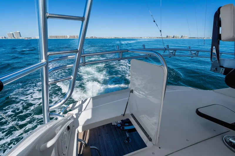 Unleashed Yacht Photos Pics 2007 Viking 56 Convertible yacht cruising on open blue waters.