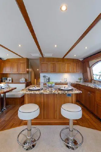 Sixpack Yacht Photos Pics Luxurious 2013 Hatteras GT63 yacht interior with modern kitchen and stylish bar stools.