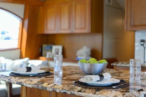 Sixpack Yacht Photos Pics Luxurious kitchen interior of 2013 Hatteras GT63 yacht with elegant dining setup.