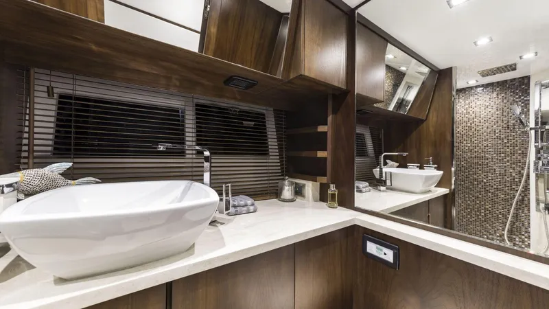  Yacht Photos Pics Luxurious bathroom interior of 2014 Galeon 550 Fly yacht with modern fixtures and wood accents.