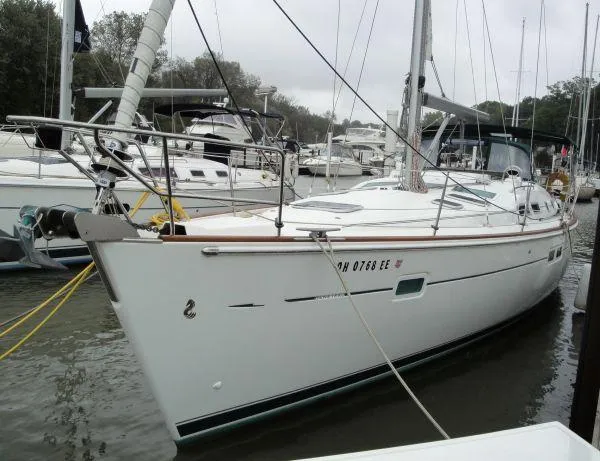 Royce Yacht Photos Pics 2007 Beneteau 423 sailboat docked in a marina, surrounded by other boats.