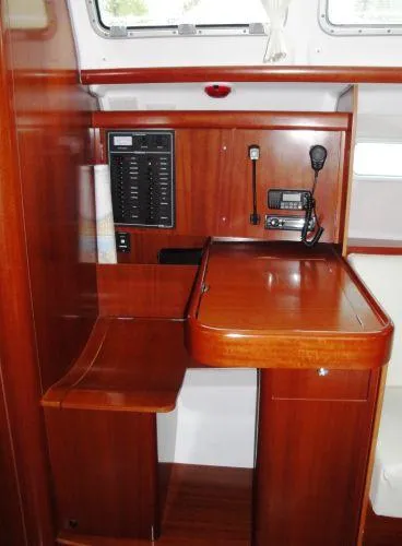 Royce Yacht Photos Pics Navigation station in 2007 Beneteau 423 sailboat with wood finish and communication equipment.