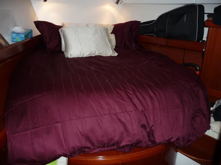 Royce Yacht Photos Pics Luxurious cabin bed with burgundy bedding in 2007 Beneteau 423 yacht.
