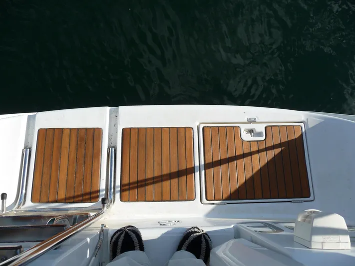 Royce Yacht Photos Pics Teak deck of 2007 Beneteau 423 yacht, overlooking calm water.