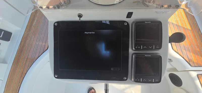 Royce Yacht Photos Pics Control panel of a 2007 Beneteau 423 sailboat with Raymarine navigation displays.