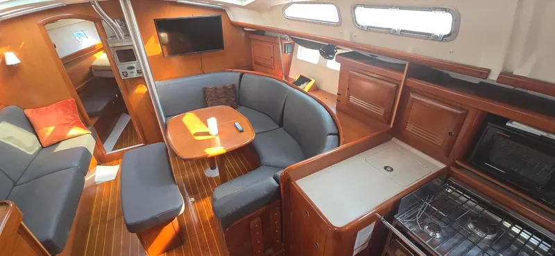 Royce Yacht Photos Pics Interior of 2007 Beneteau 423 sailboat with cozy seating, dining area, and kitchen amenities.