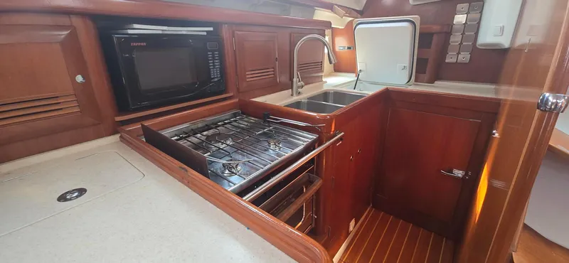 Royce Yacht Photos Pics Galley kitchen in 2007 Beneteau 423 yacht with stove, microwave, and sink.