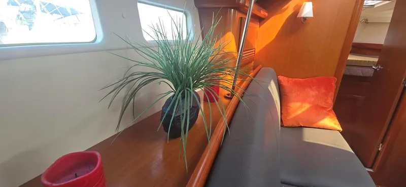 Royce Yacht Photos Pics Interior of 2007 Beneteau 423 yacht with plant and red cushions.