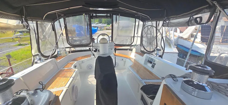 Royce Yacht Photos Pics Cockpit of a 2007 Beneteau 423 sailboat with covered seating and steering wheel.