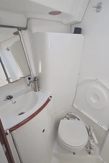Royce Yacht Photos Pics Beneteau 423 2007 yacht bathroom with sink, mirror, and toilet.