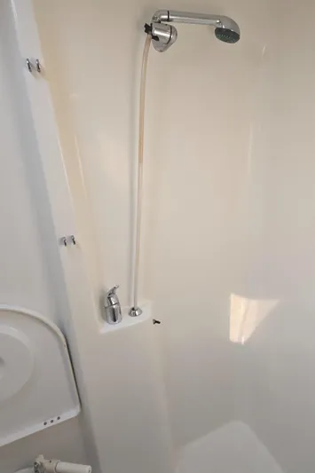 Royce Yacht Photos Pics Shower area in a 2007 Beneteau 423 yacht, featuring a sleek chrome showerhead.