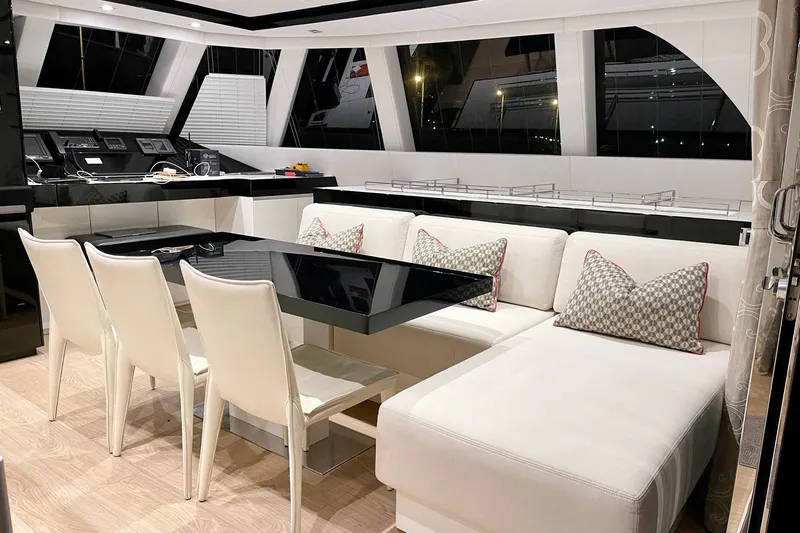 Deo Juvante Yacht Photos Pics Luxurious interior of 2018 Sunreef 62 ARC yacht with elegant seating and dining area.