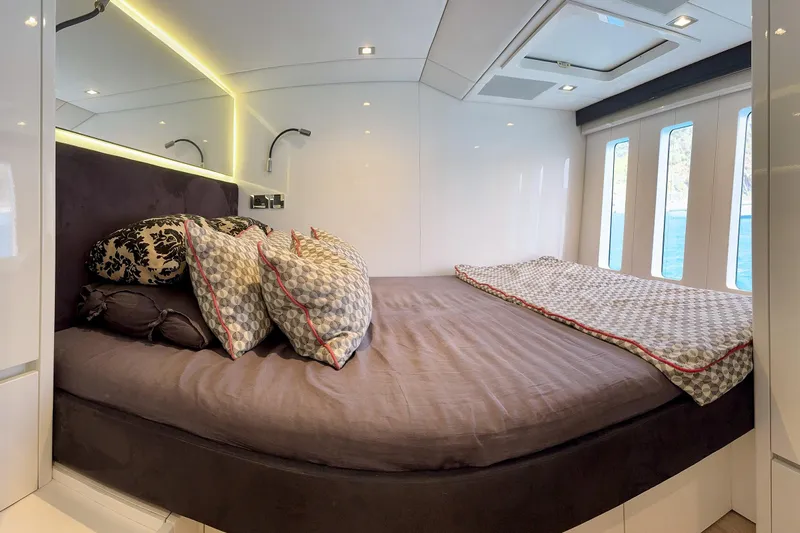 Deo Juvante Yacht Photos Pics Luxurious bedroom interior of 2018 Sunreef 62 ARC yacht with elegant bedding and modern lighting.