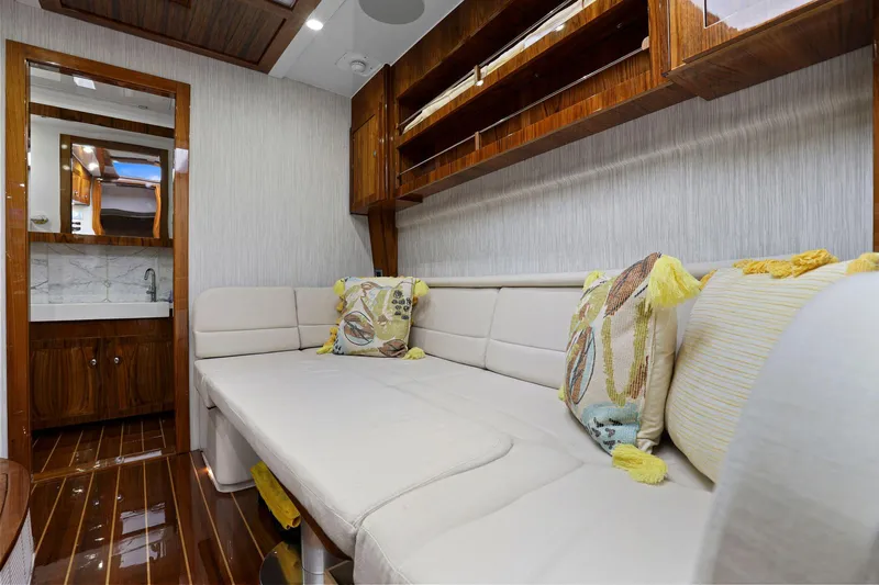 Big Momma Yacht Photos Pics Luxurious interior of 2023 HCB 65 Estrella yacht with plush seating and elegant wood finishes.