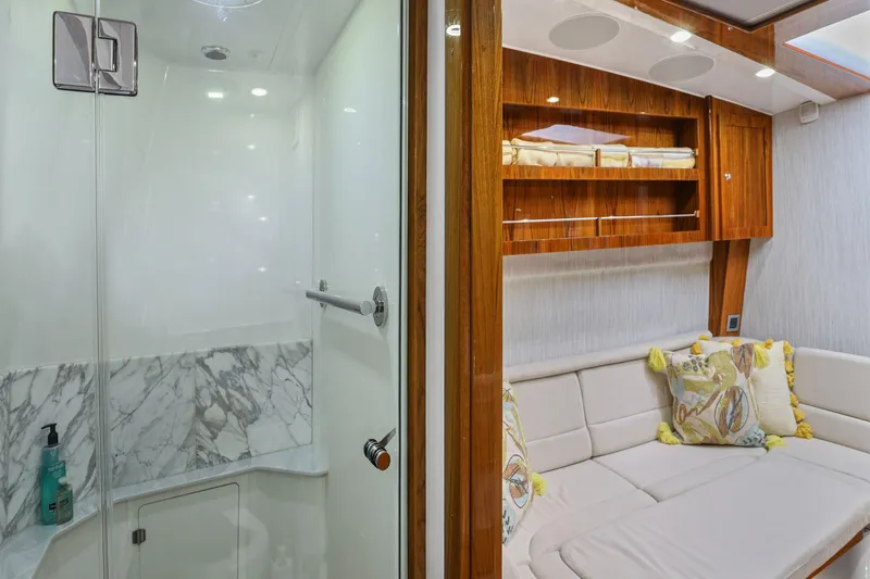 Big Momma Yacht Photos Pics Luxurious interior of 2023 HCB 65 Estrella yacht featuring a modern shower and cozy seating area.