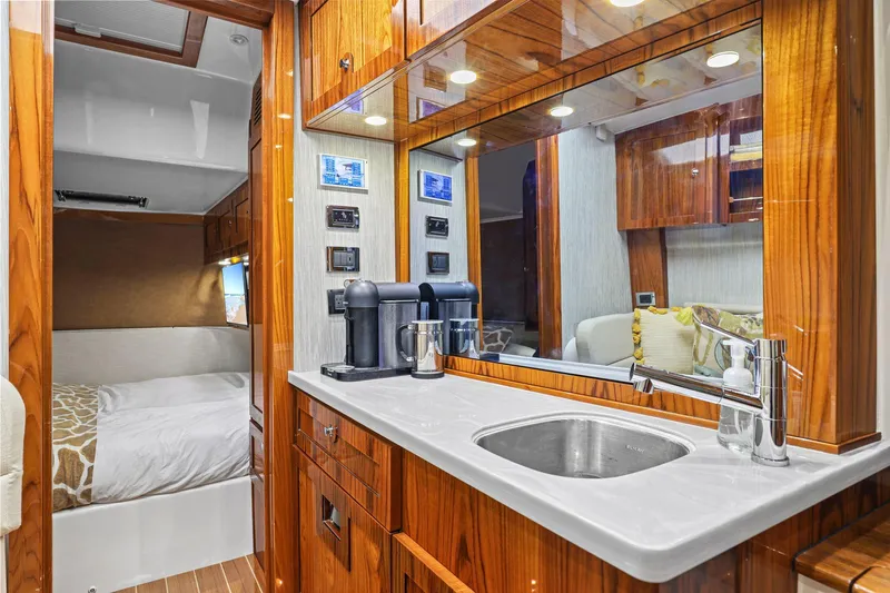 Big Momma Yacht Photos Pics Luxurious interior of 2023 HCB 65 Estrella yacht with wood finishes and modern amenities.