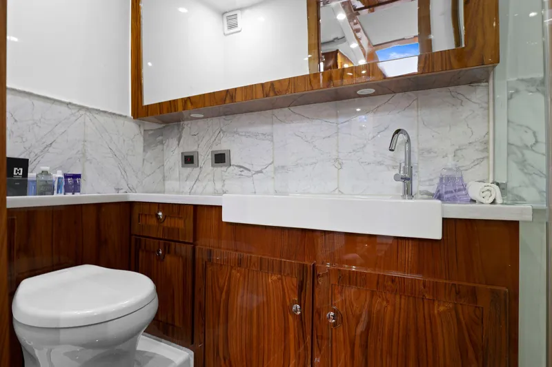 Big Momma Yacht Photos Pics Luxurious bathroom in 2023 HCB 65 Estrella yacht with marble and wood finishes.