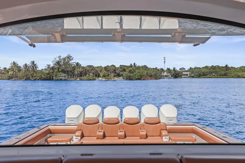 Big Momma Yacht Photos Pics 2023 HCB 65 Estrella yacht with luxurious seating, overlooking serene blue waters and lush greenery.