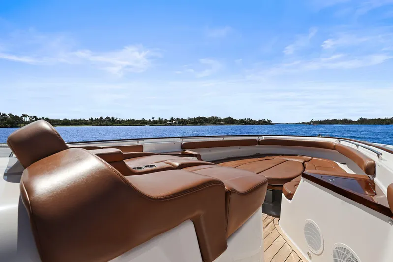 Big Momma Yacht Photos Pics Luxurious seating on 2023 HCB 65 Estrella yacht, overlooking serene blue waters and clear sky.