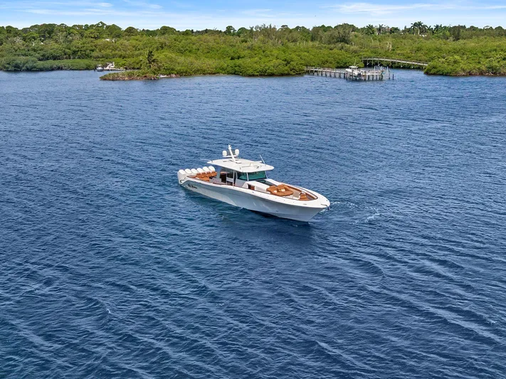 Big Momma Yacht Photos Pics 2023 HCB 65 Estrella luxury yacht cruising on a serene blue lake near lush green shoreline.