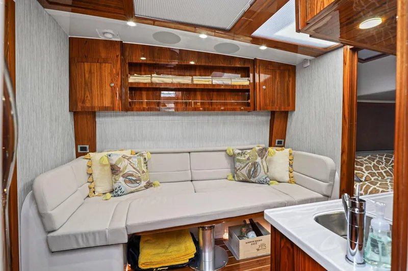 Big Momma Yacht Photos Pics Luxurious interior of 2023 HCB 65 Estrella yacht with plush seating and elegant wood finishes.