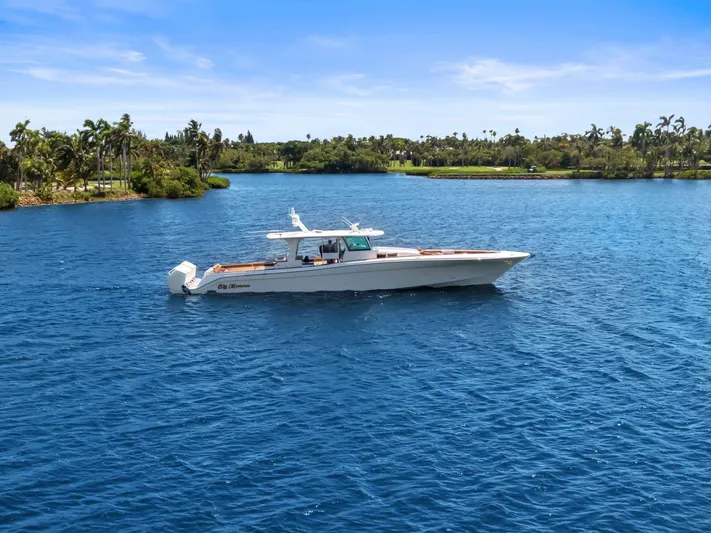 Big Momma Yacht Photos Pics 2023 HCB 65 Estrella yacht cruising on a serene blue lake with lush greenery.