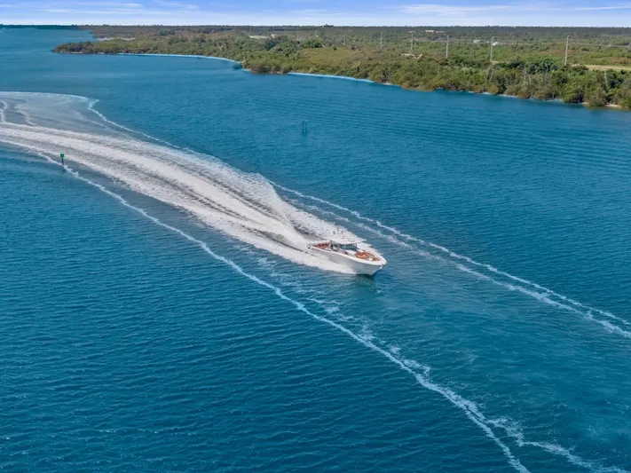 Big Momma Yacht Photos Pics 2023 HCB 65 Estrella cruising on a scenic blue waterway.