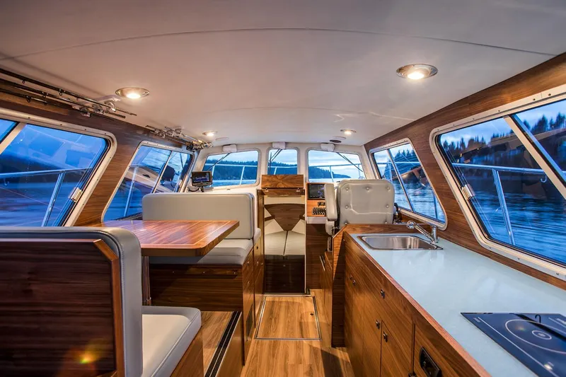 Hardy Yacht Photos Pics Manufacturer Provided Image: Interior of 2020 Coastal Craft 33 ProFish boat with modern wood finishes and panoramic windows.
