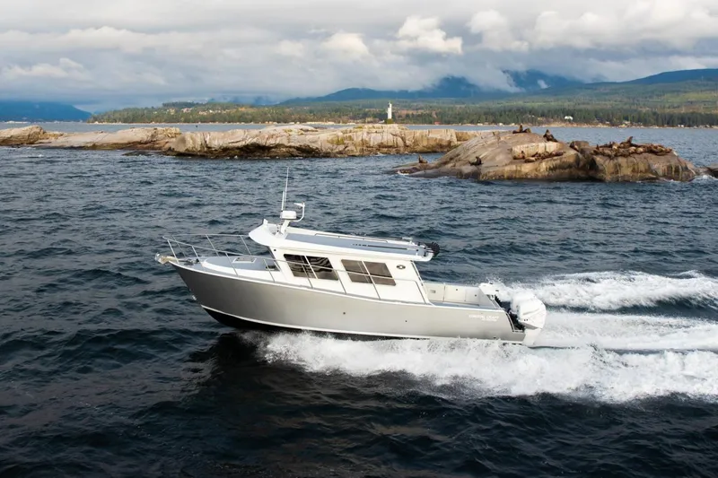 Hardy Yacht Photos Pics Manufacturer Provided Image: 2020 Coastal Craft 33 ProFish boat cruising near rocky shoreline.