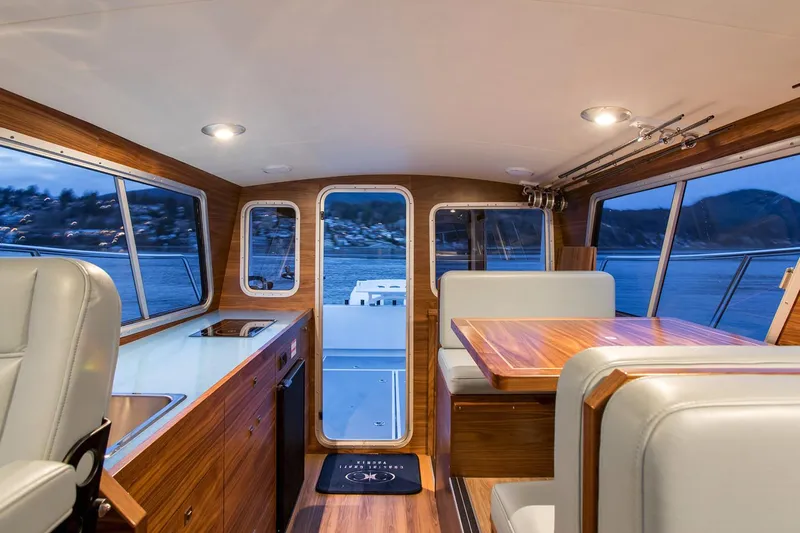 Hardy Yacht Photos Pics Manufacturer Provided Image: Interior of 2020 Coastal Craft 33 ProFish boat with wood finishes and seating area.