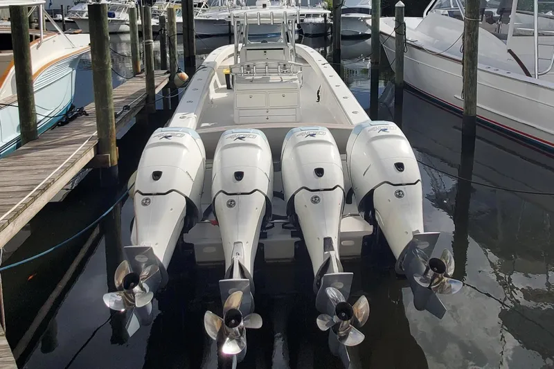 Dragonfly Yacht Photos Pics 2014 Bahama 41 FS boat with four powerful outboard engines docked at a marina.