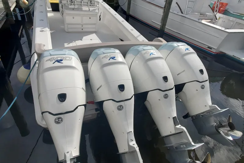 Dragonfly Yacht Photos Pics 2014 Bahama 41 FS boat with four powerful outboard engines docked in marina.