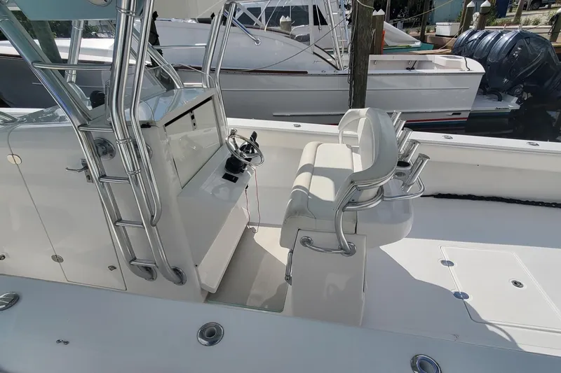 Dragonfly Yacht Photos Pics 2014 Bahama 41 FS boat interior with helm station and seating, docked at marina.