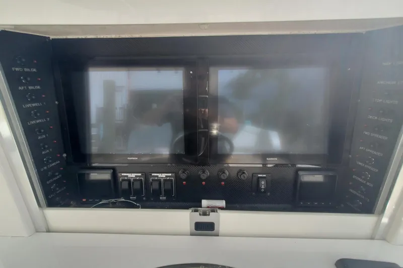 Dragonfly Yacht Photos Pics Control panel of a 2014 Bahama 41 FS boat with dual screens and switches.