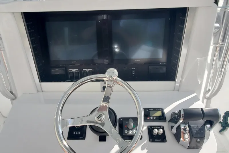 Dragonfly Yacht Photos Pics Control panel of 2014 Bahama 41 FS boat with steering wheel and navigation screens.