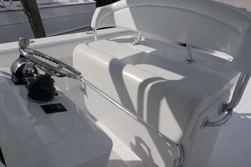 Dragonfly Yacht Photos Pics 2014 Bahama 41 FS boat helm with white cushioned seating and steering wheel.